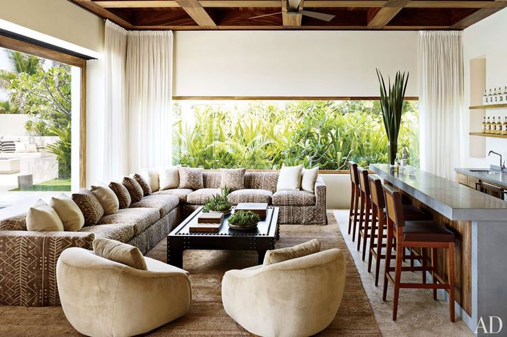 Clooney's bar area: The actor’s bar area is furnished with a custom-made sectional sofa upholstered in a Ralph Lauren Home fabric and a pair of vintage suede lounge chairs; the barstools were made locally.