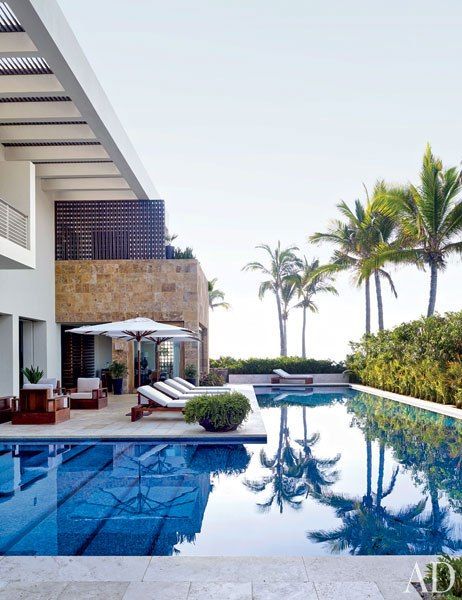 Clooney's Pool: Santa Barbara Designs umbrellas complement custom-made Jasper teak seating on the pool terrace.